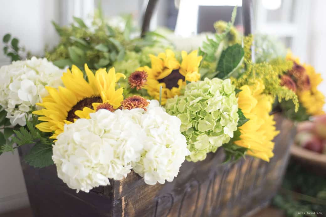 hydrangeas and sunflowers in a bakset