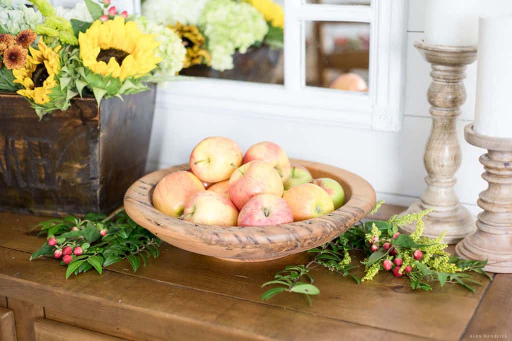 wooden bowl filled with apples