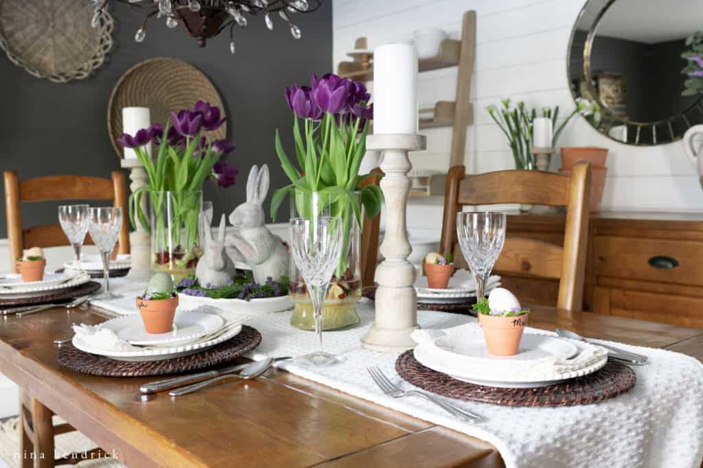Purple Easter Tablescape with wood candleholders and crystal glasses.