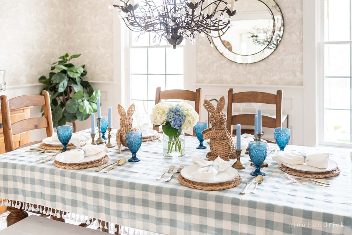 Easter table setting with wicker and brass accents. 