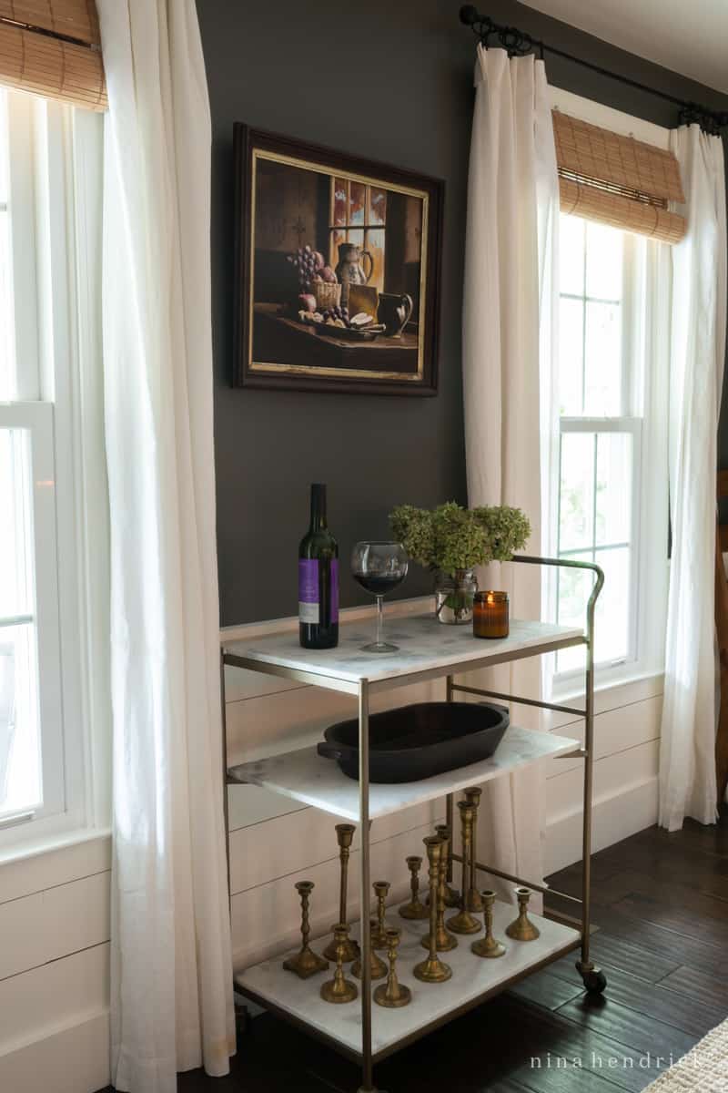An elegant bar cart in a living room, creating a stylish fall tablescape.