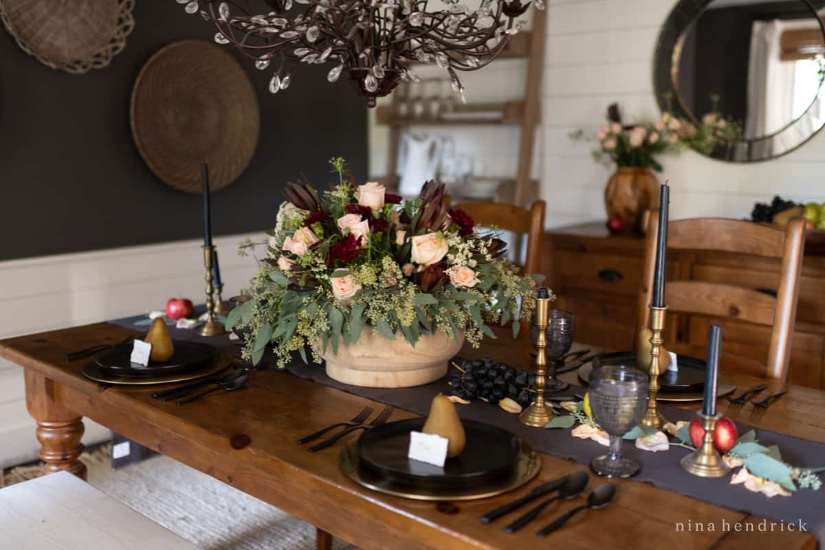 Thanksgiving table setting with black and gold decor.