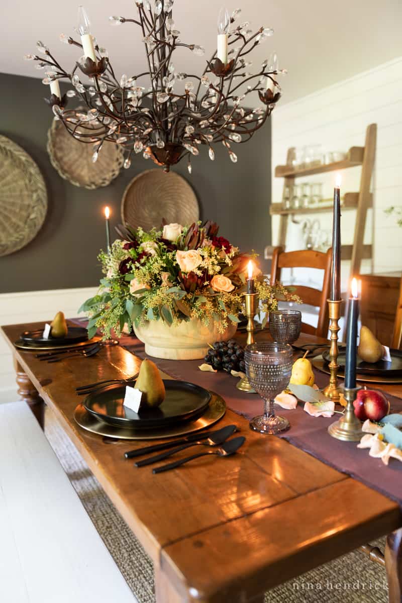 An elegant dining room table is decorated for Thanksgiving