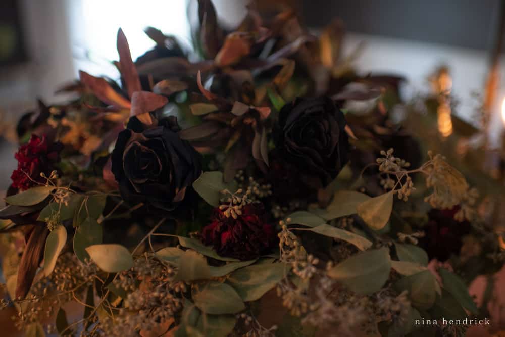 Spooky Halloween floral arrangement with black roses and dried leucadendron