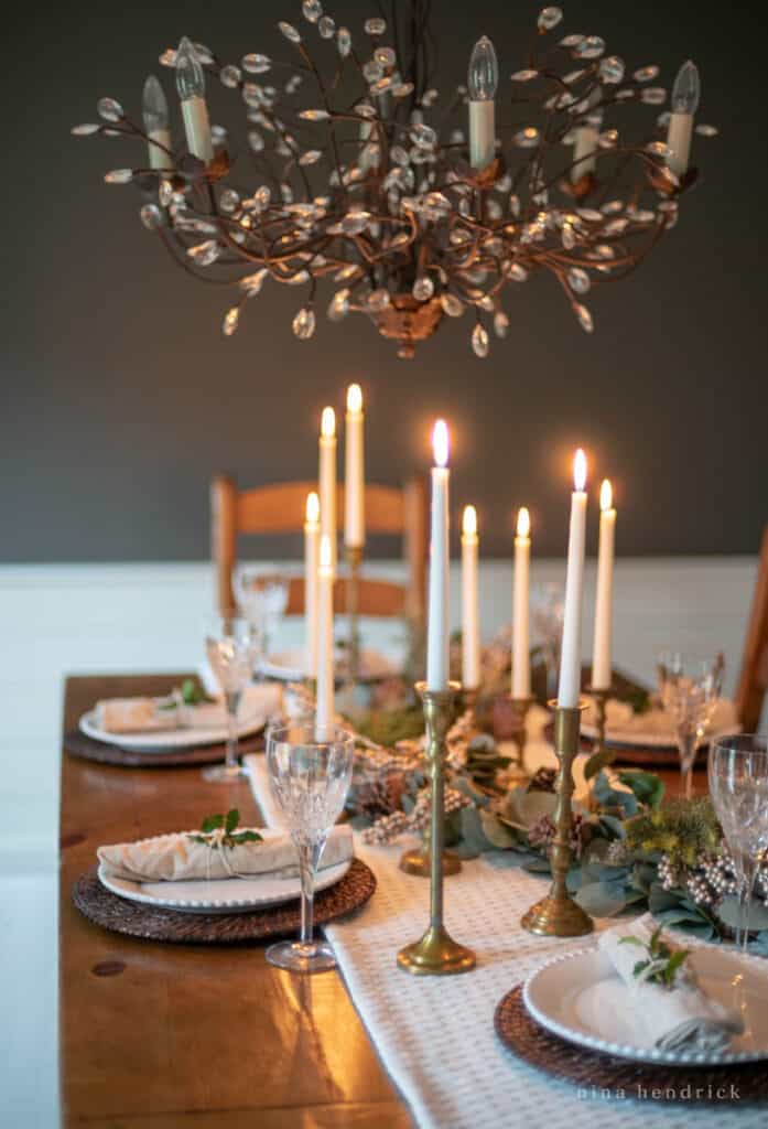 Elegant winter tablescape with glittering crystal and evergreens