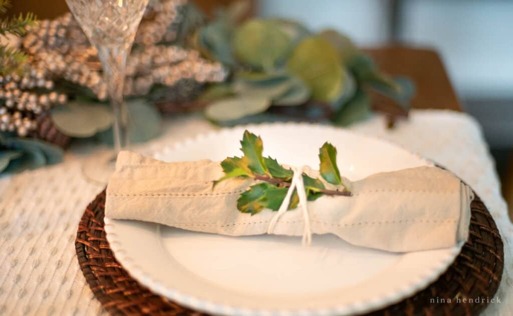winter place setting with evergreen clipping
