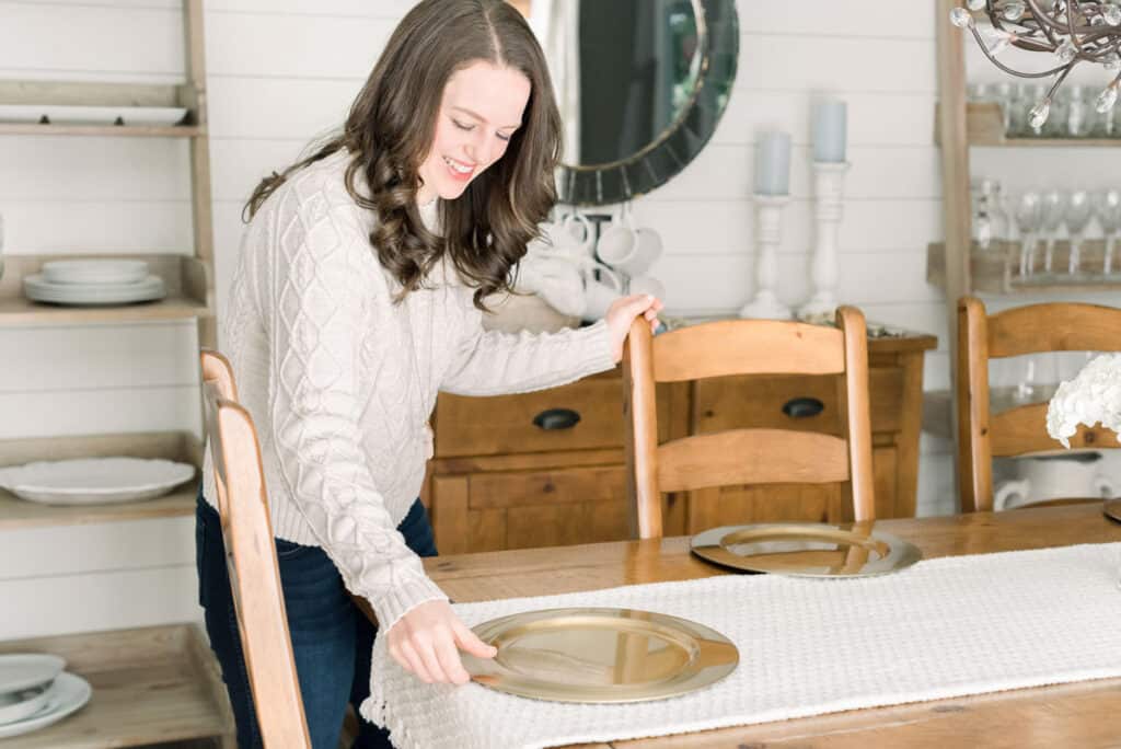 Nina Hendrick entertaining essentials and basics — setting down a brass charger in the dining room for a tablescape