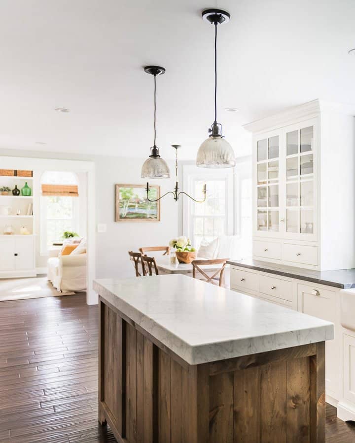 Empty kitchen with marble countertops and white cabinets