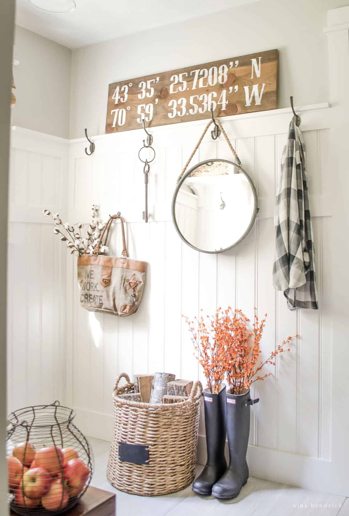 A fall home tour featuring a cozy entryway with baskets, boots, and a sign.