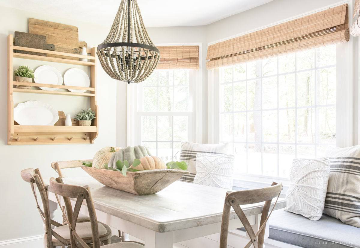 A fall home tour featuring a dining room with a white table and chairs.