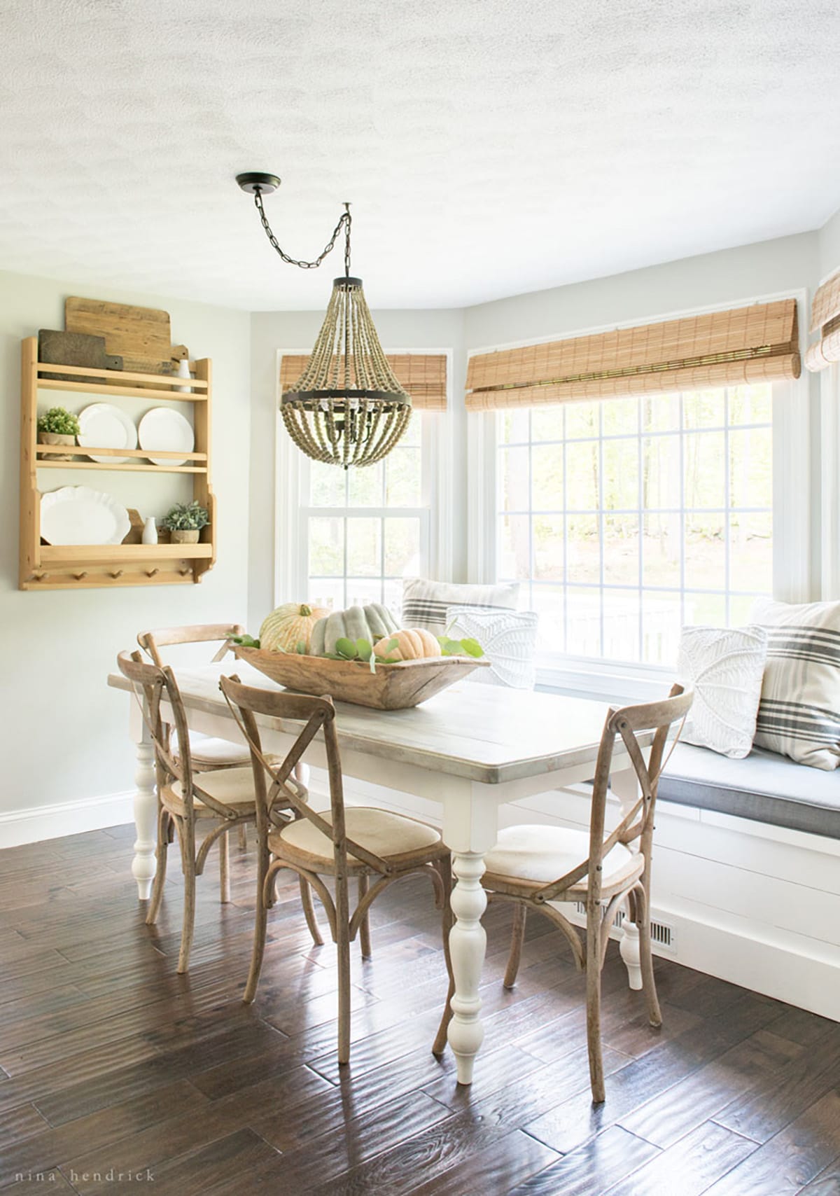 A cozy dining room with a wooden table and chairs, perfect for a fall home tour.