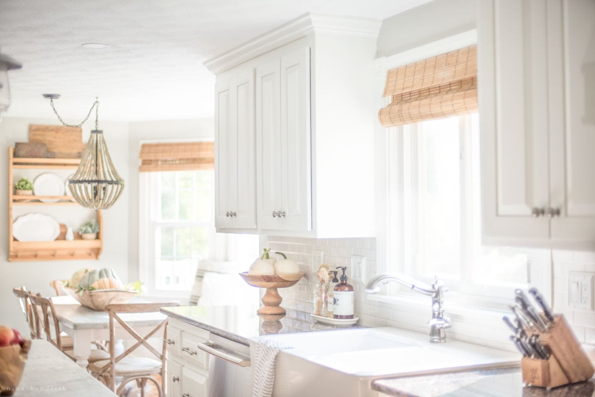 A fall home tour featuring a kitchen with white cabinets and a white sink.