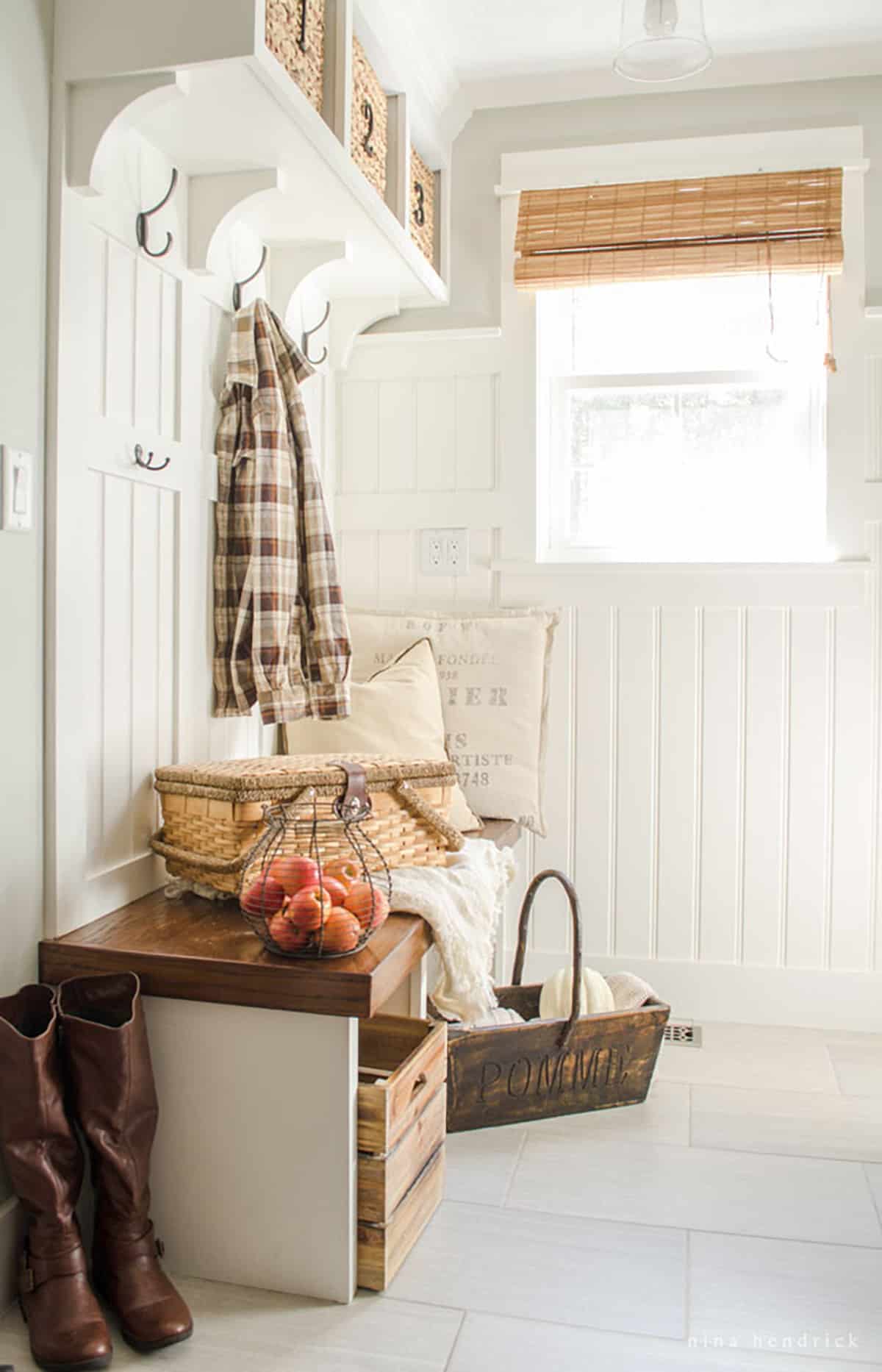 A mudroom with a fall-inspired bench and baskets.
