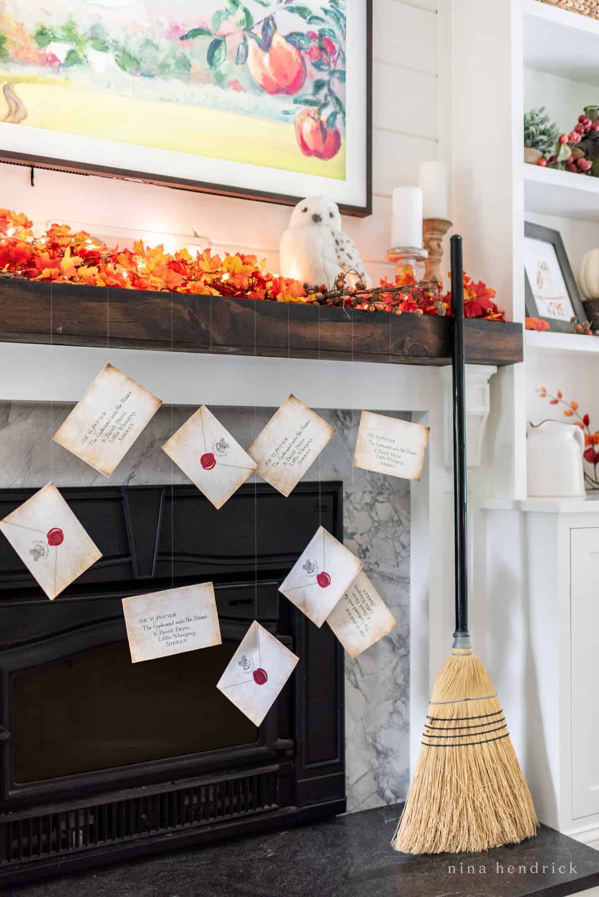 Hogwarts letters hanging from the fireplace for Halloween. 