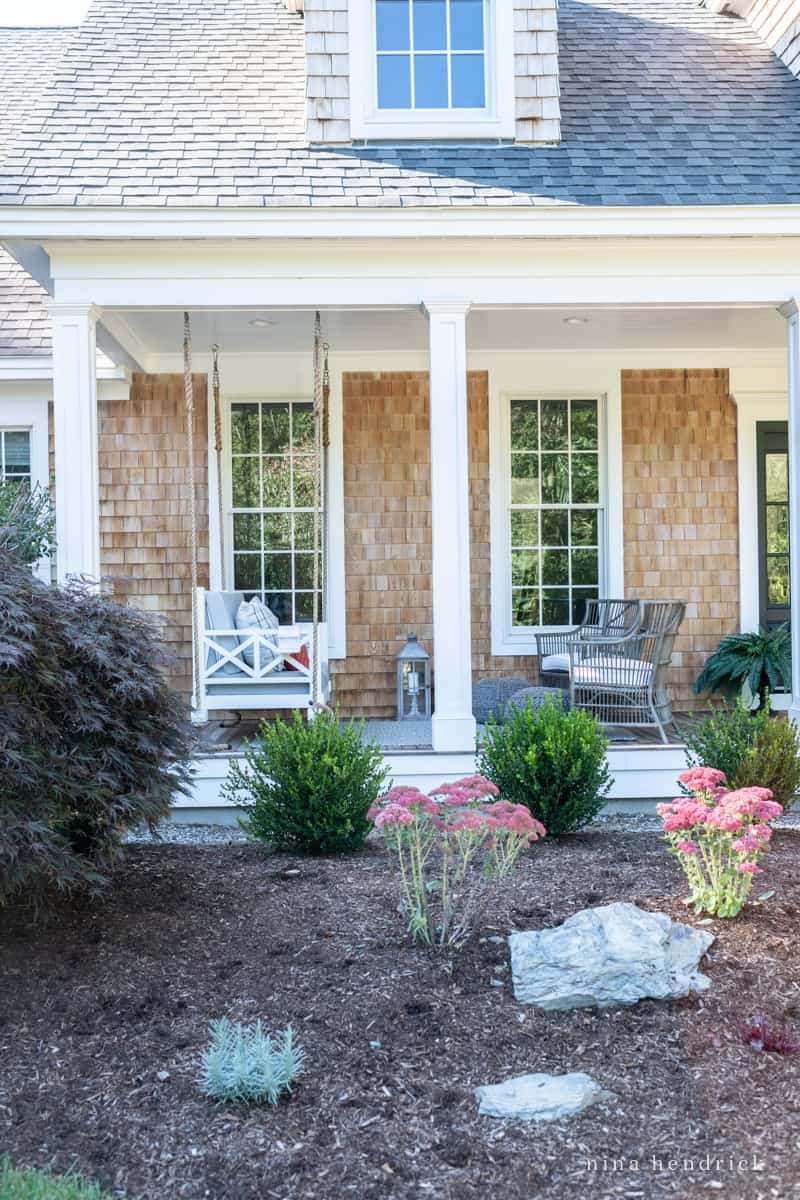 A farmhouse porch with a swing.