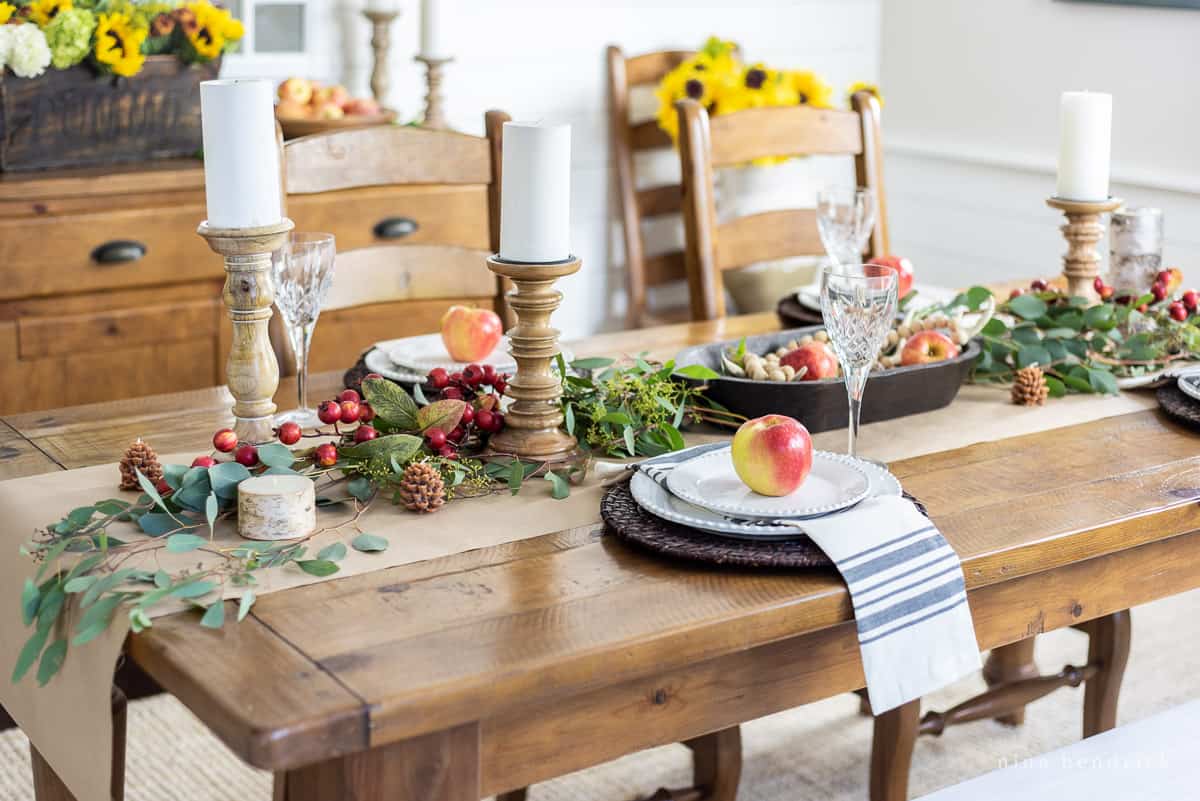 Thanksgiving table setting with fall table decor and pumpkins.