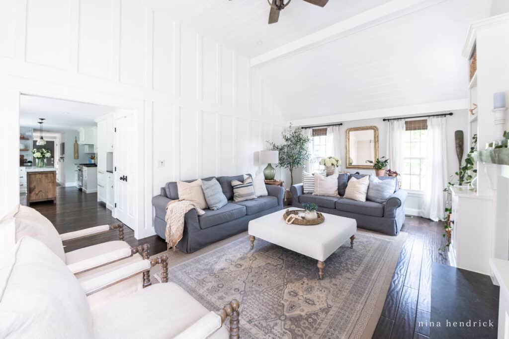 White family room with board-and-batten and tongue-and-groove with charcoal sofas.