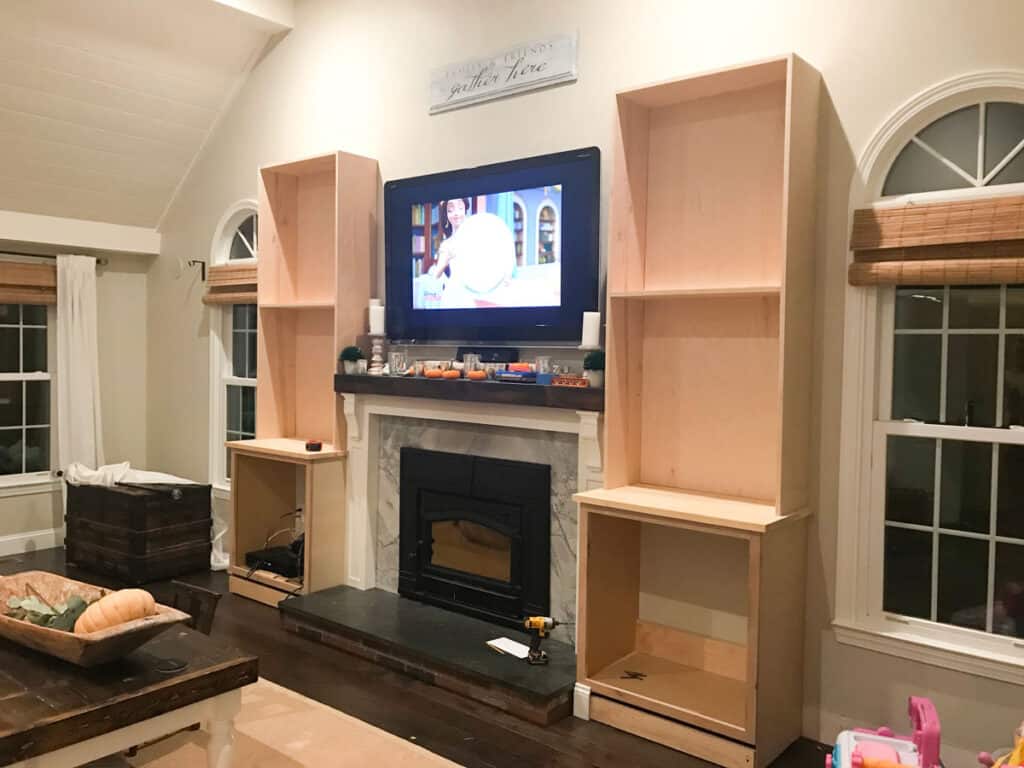 DIY Fireplace built-in cabinets from stock cabinets and custom bookshelves.