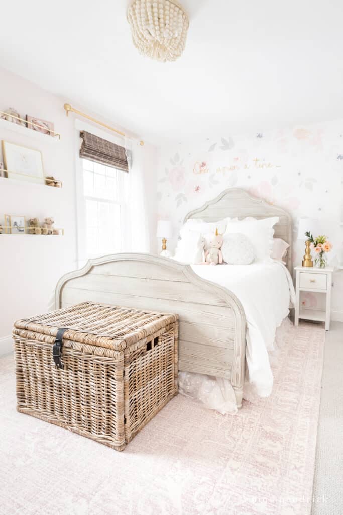 Girl's floral room makeover with vintage-inspired rug and wicker chest