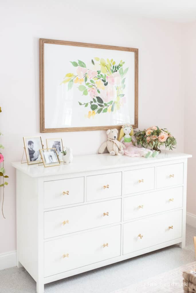 Fairy Tale Blush Floral Girl room Makeover gold bows on dresser and gold frames.