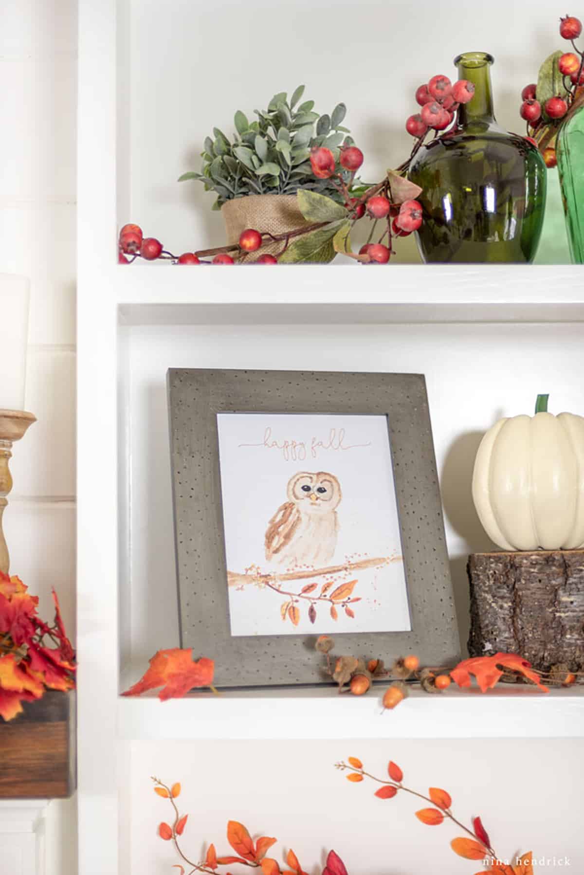 A white shelf with fall decorations and a free "Happy Fall" printable featuring an owl.