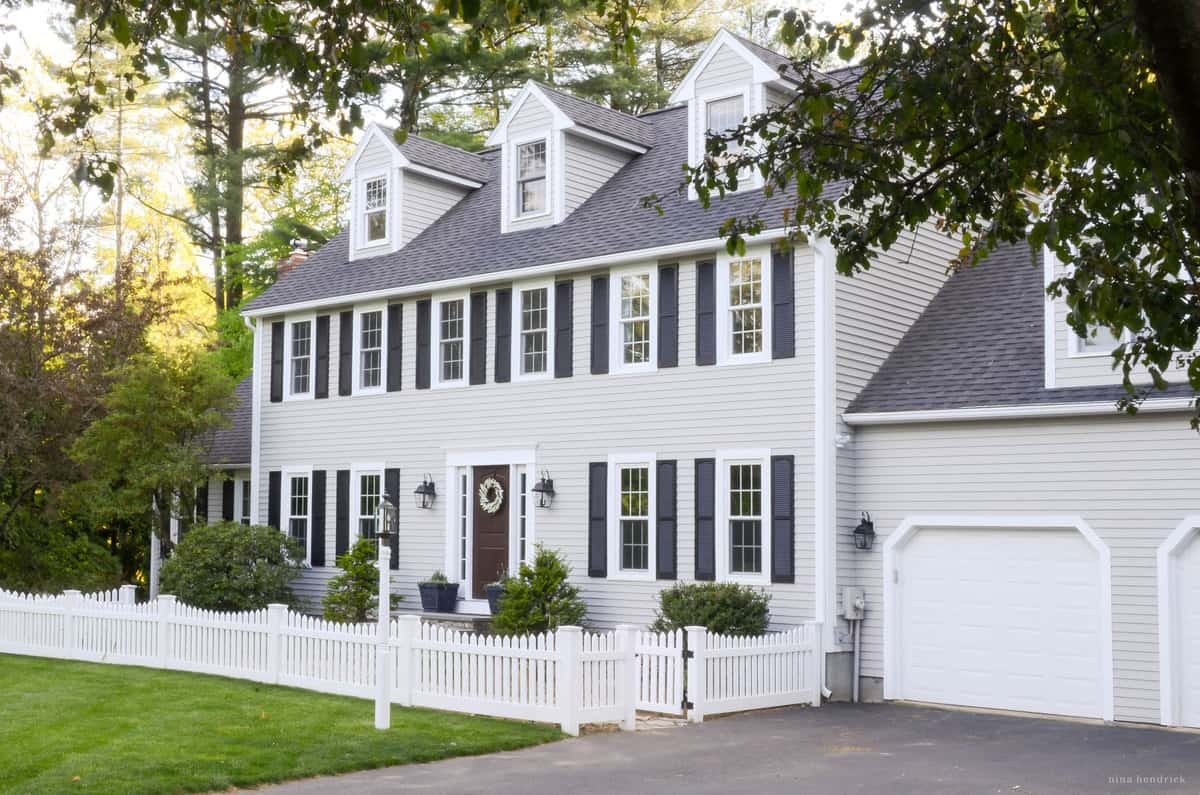 A colonial home painted Gray Huskie by Benjamin Moore.