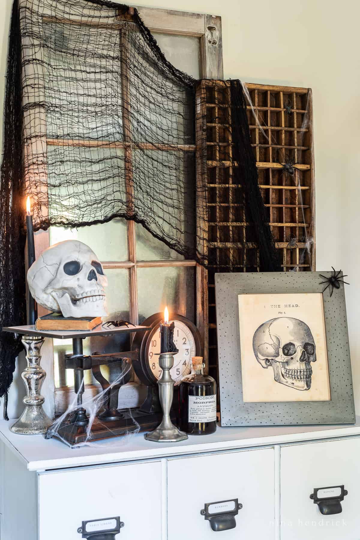 Looking for Halloween decorating ideas? Check out this black dresser adorned with spooky skulls and flickering candles.