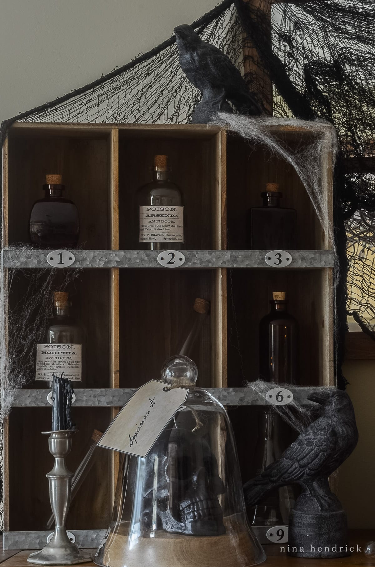 A spooky shelf with bottles and crows, perfect for Halloween decorating ideas.