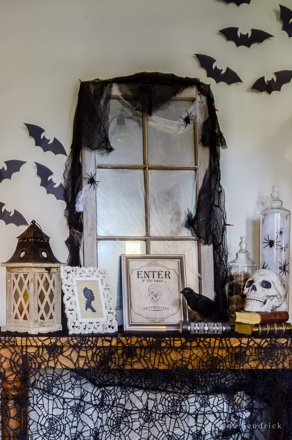 Get inspired with this spooktacular Halloween foyer, adorned with bats and spider webs.