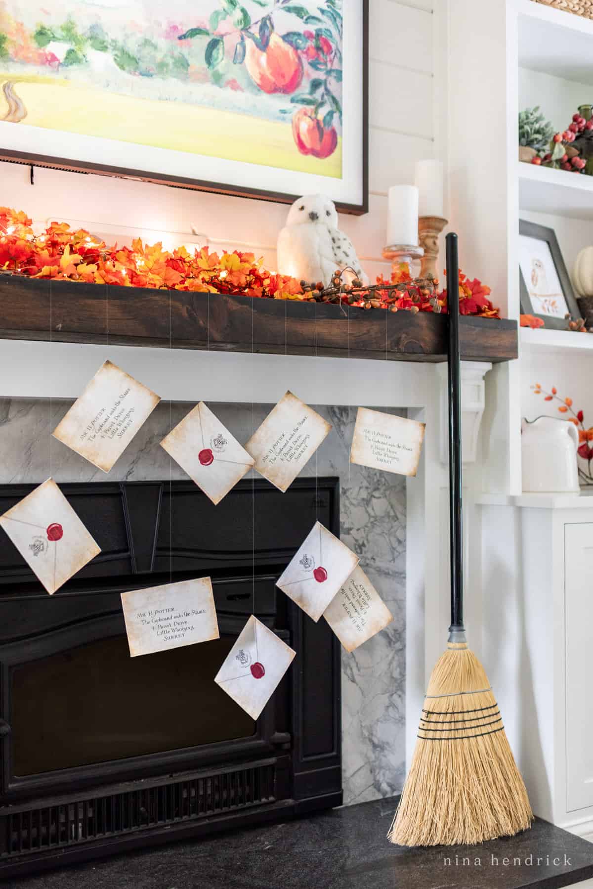 Get inspired with Halloween decorating ideas as you imagine a mantle adorned with a broom and fall cards.