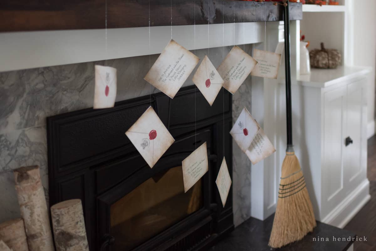 A mantle with a broom hanging from it, reminiscent of a Hogwarts acceptance letter.