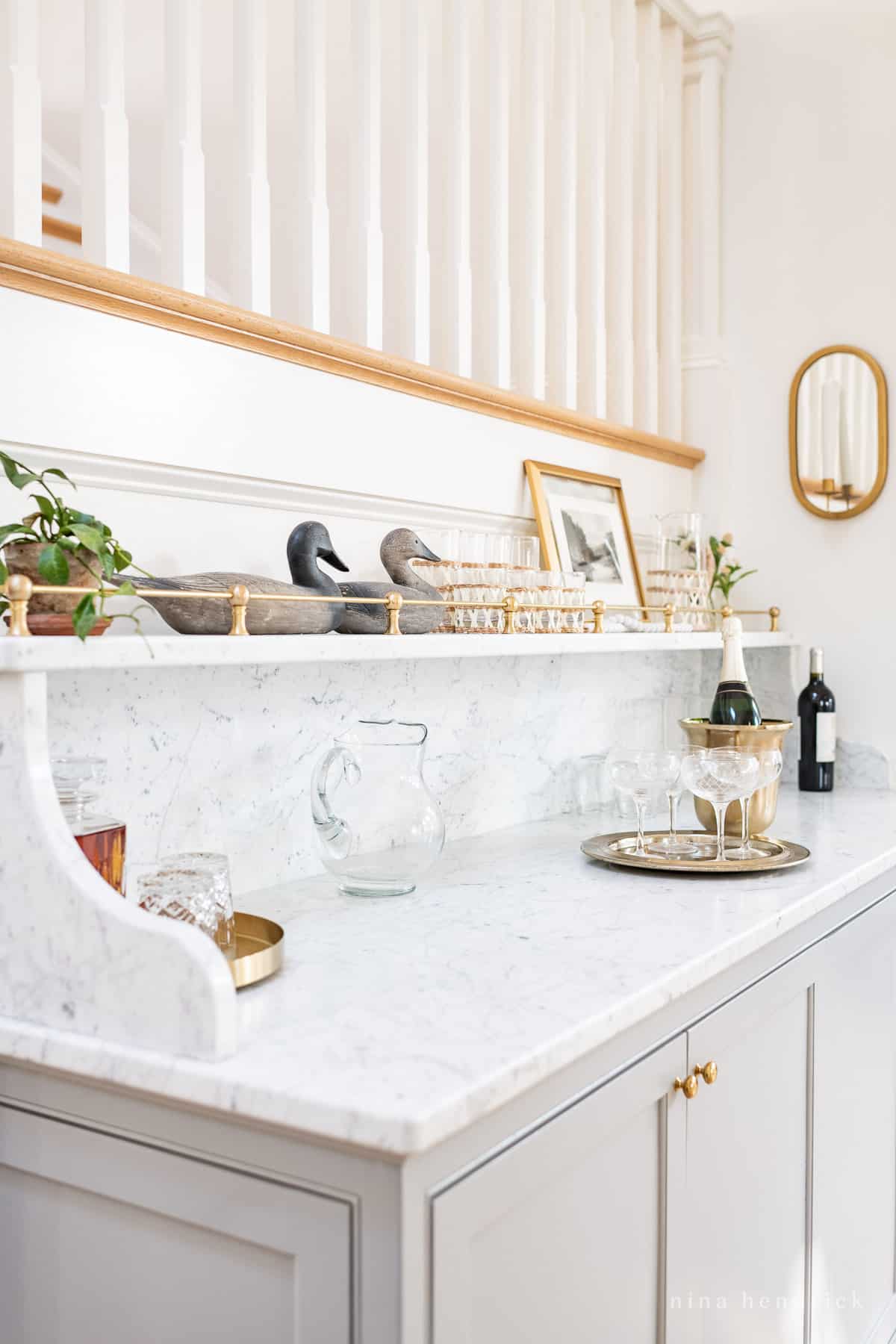 Built-in bar below the stairs with decorating and glassware ideas for entertaining