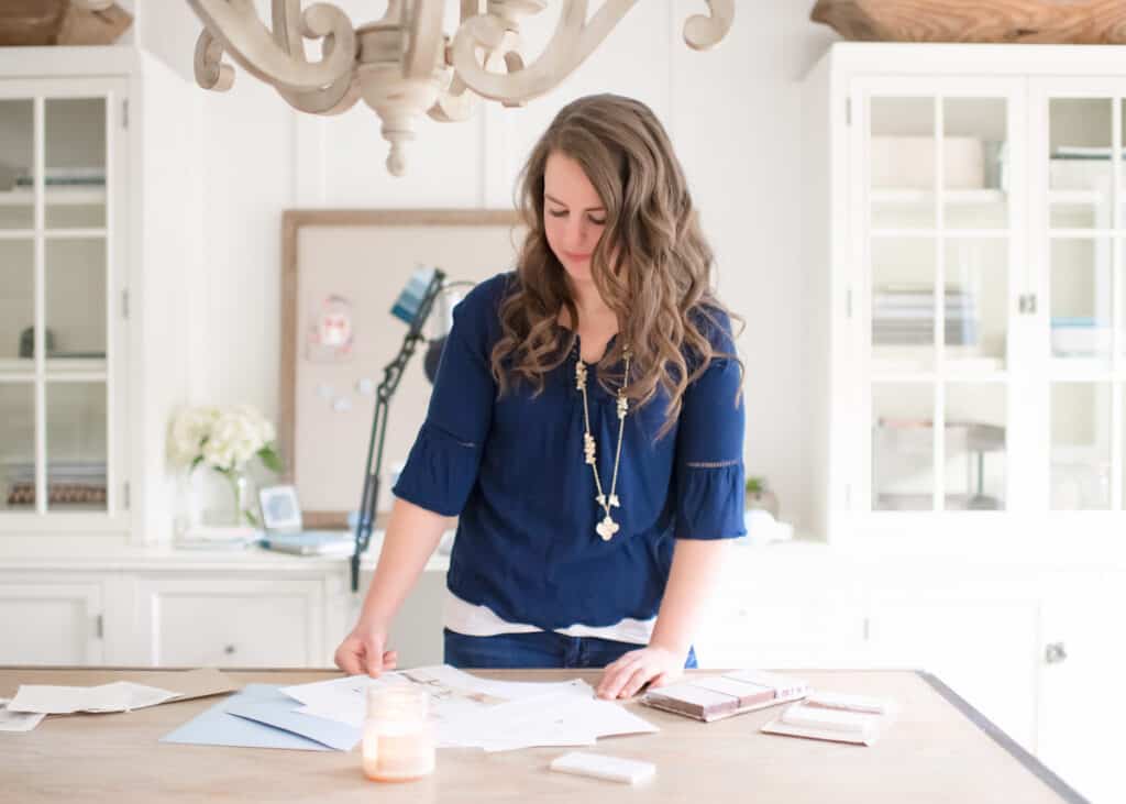 Nina Hendrick looking over design plans in a white office