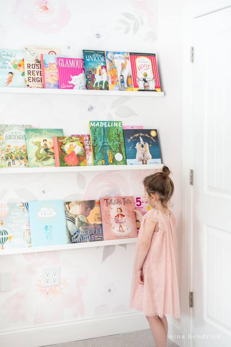 Ideas for organizing books in a kids room — ledges installed so books are off floor but still down low.