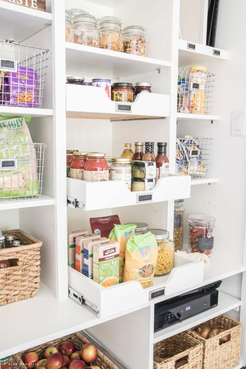 Pantry with storage pulled out for access to canned items at the back of shelves