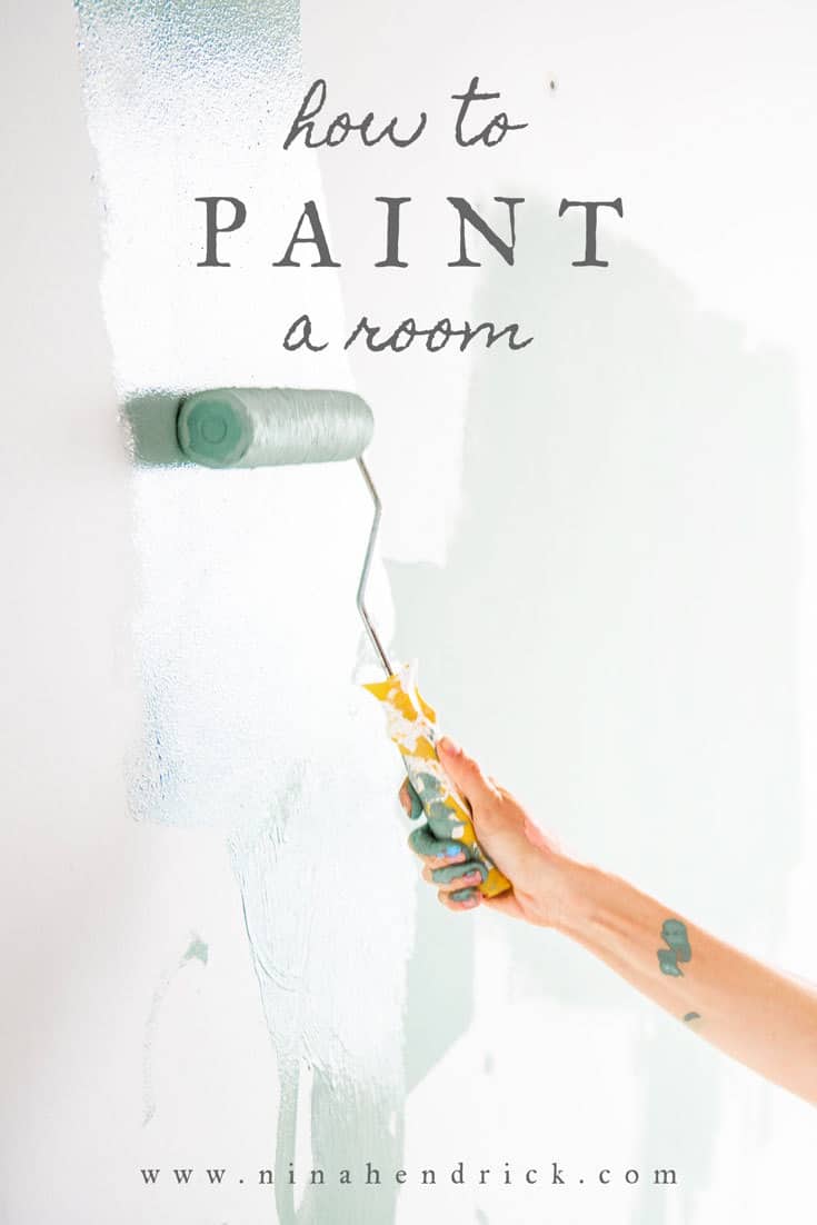 Hand with paint roller How to Paint a Room