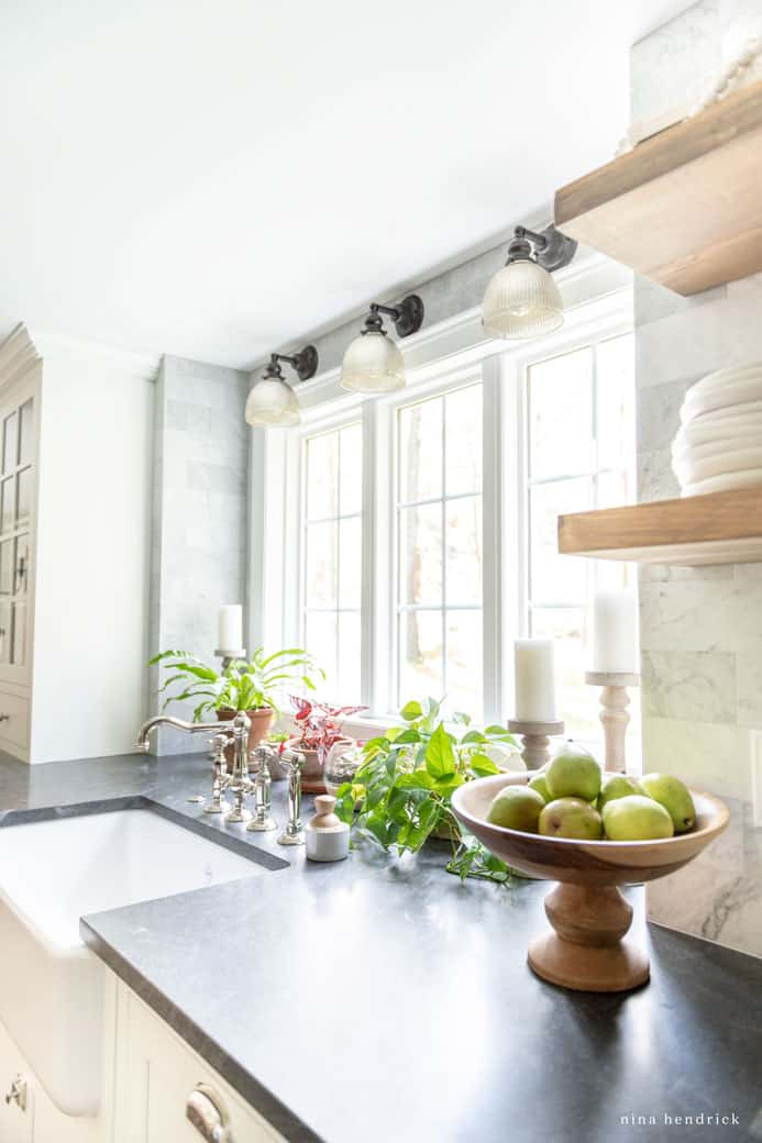 Plants and natural light to bring warmth to a white kitchen