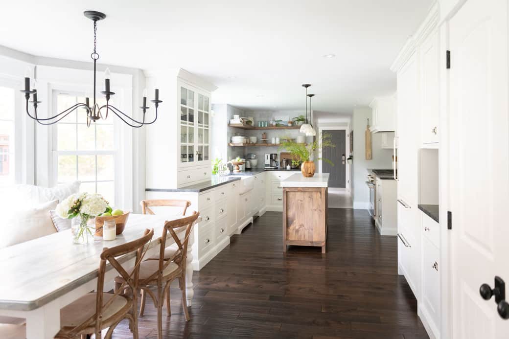 Warm white kitchen with wood accents and dark floors