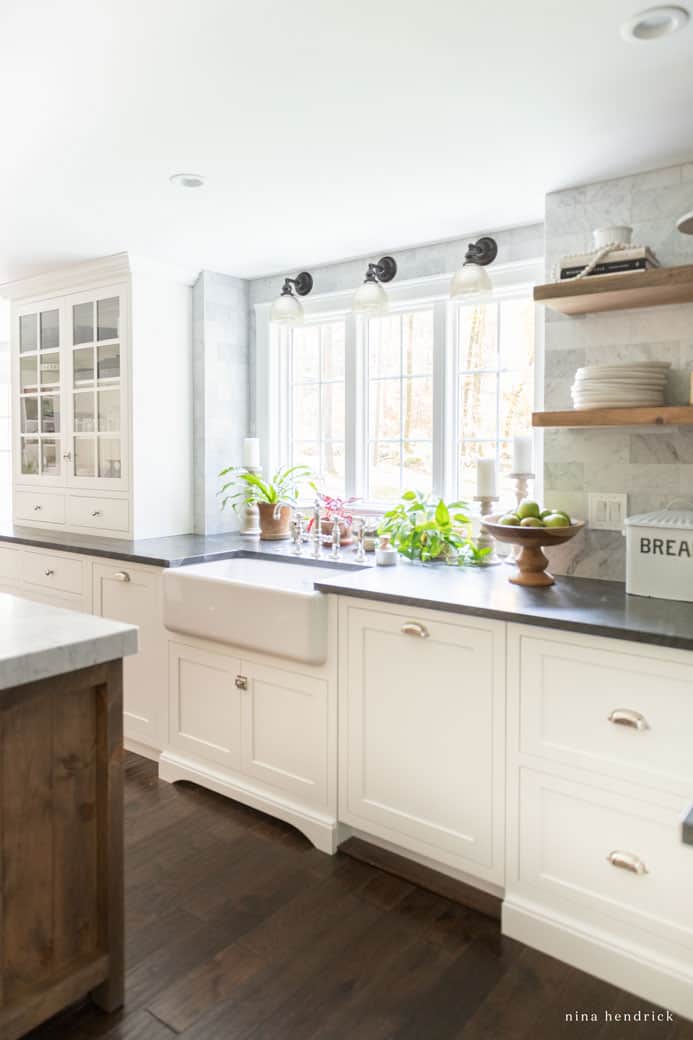 Warm up a white kitchen with dark floors and countertops for contrast.