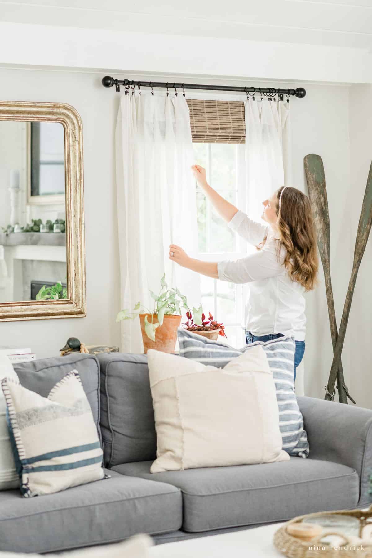 Nina Hendrick showing inexpensive window treatments in her living room