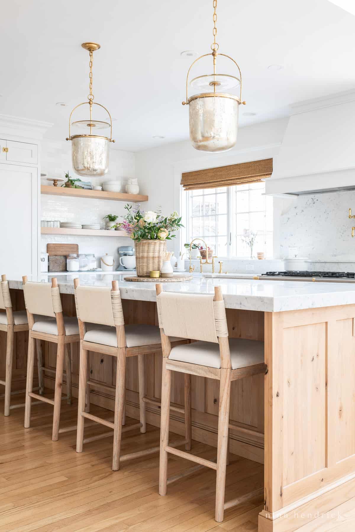 Kitchen with mercury glass pendant lighting and wood island