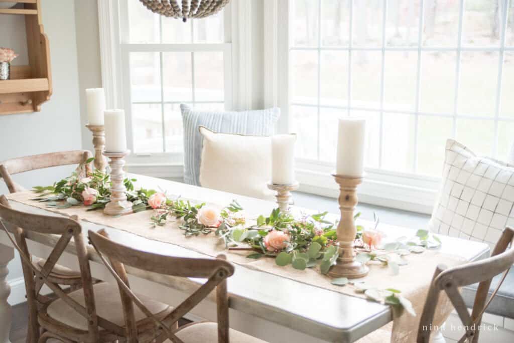 English garden inspired centerpiece in a breakfast nook with french x-back chairs