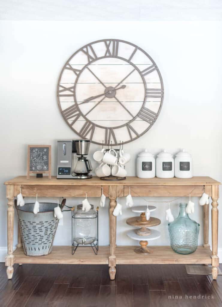 Kitchen coffee bar on a wooden table with a giant clock