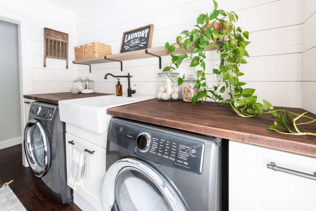 Laundry room makeover with white walls and a long trailing houseplant