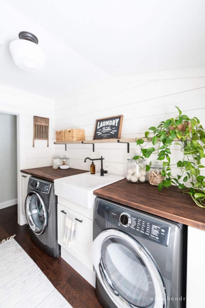 laundry room makeover with a laundry sucks sign 