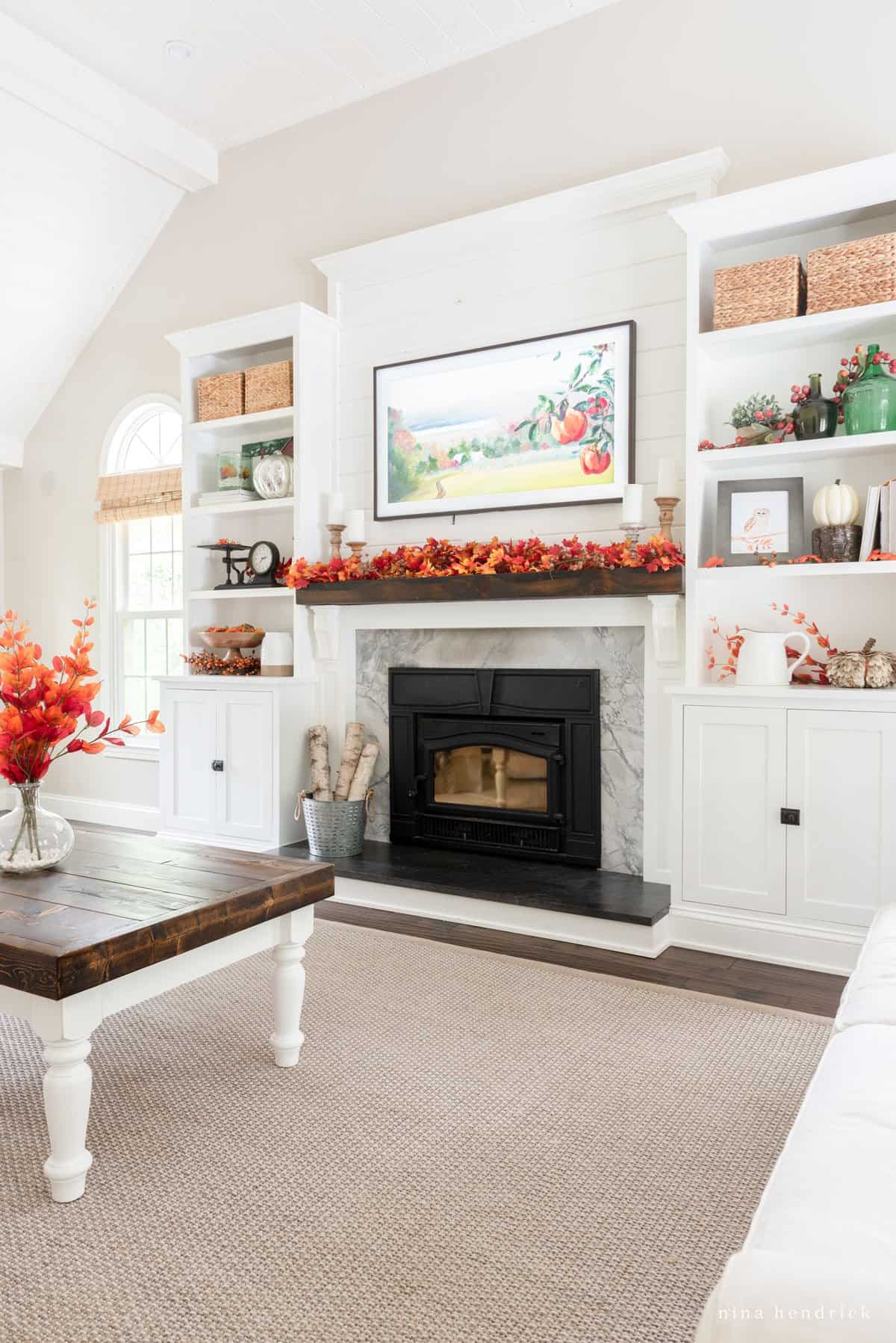 A living room with a fireplace and a coffee table.