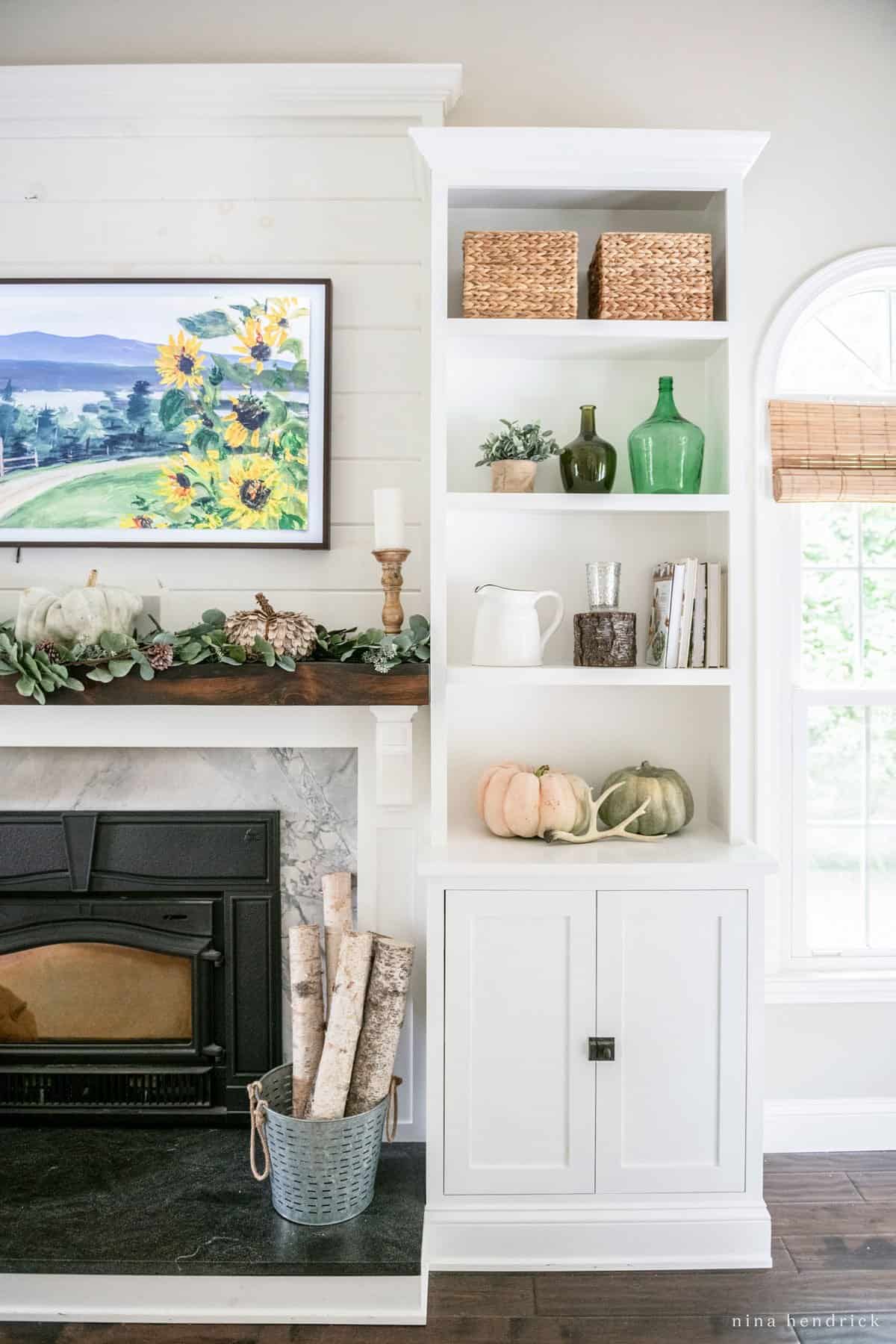 A living room with a white fireplace and bookshelves.