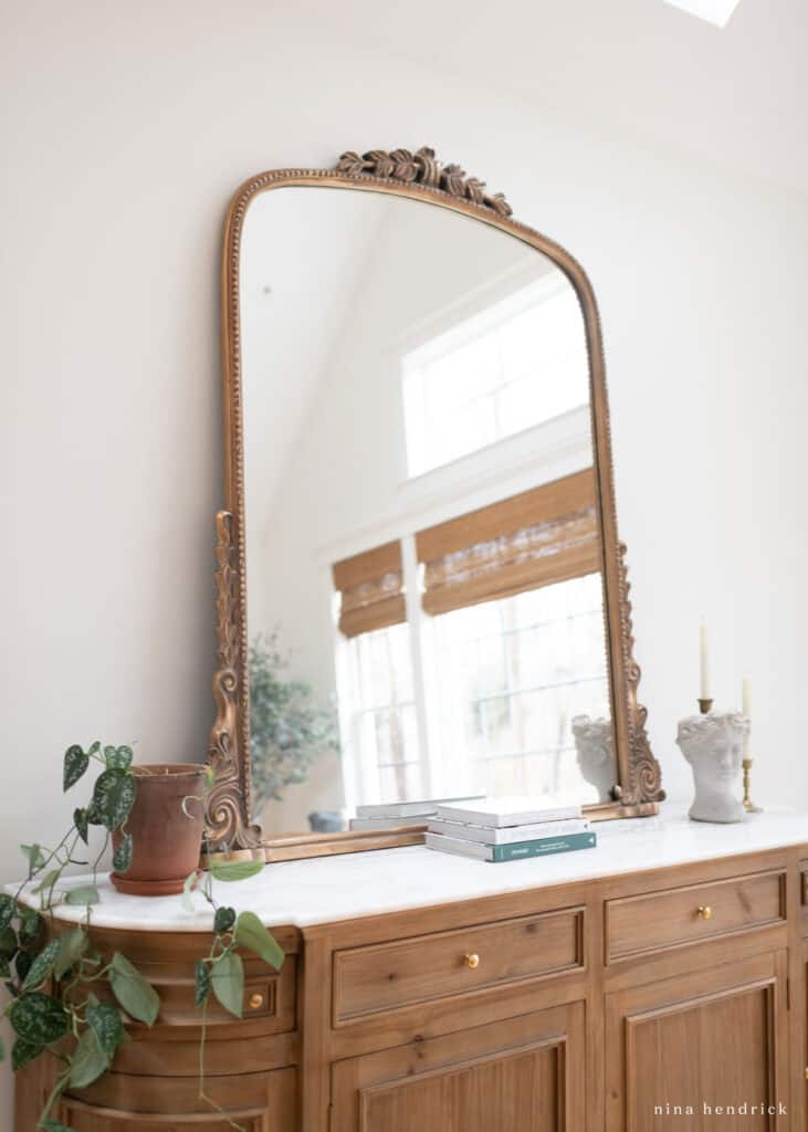 Anthropologie gleaming primrose mirror above a buffe