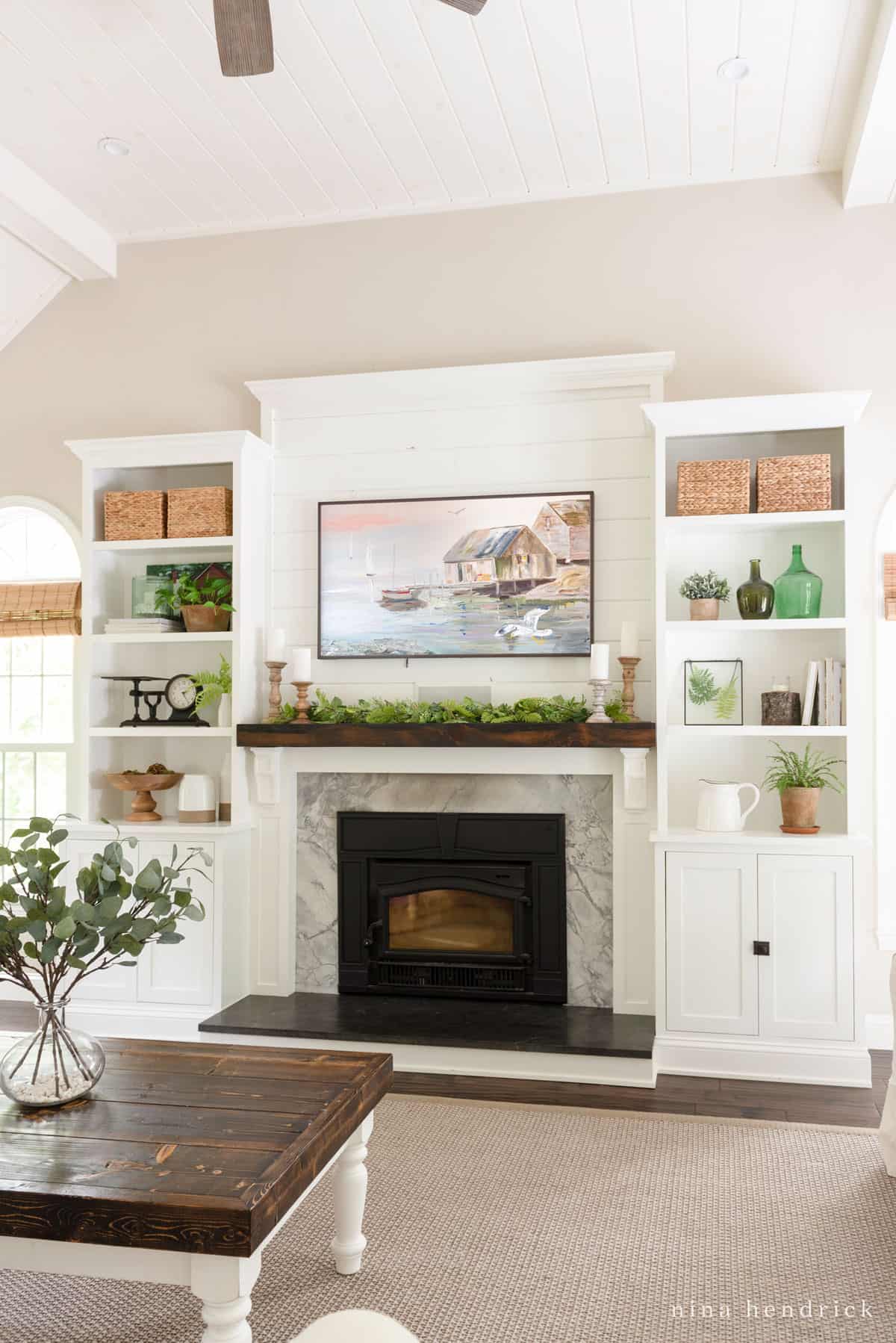 White Fireplace built-in surround with rustic mantel and fern garland decor