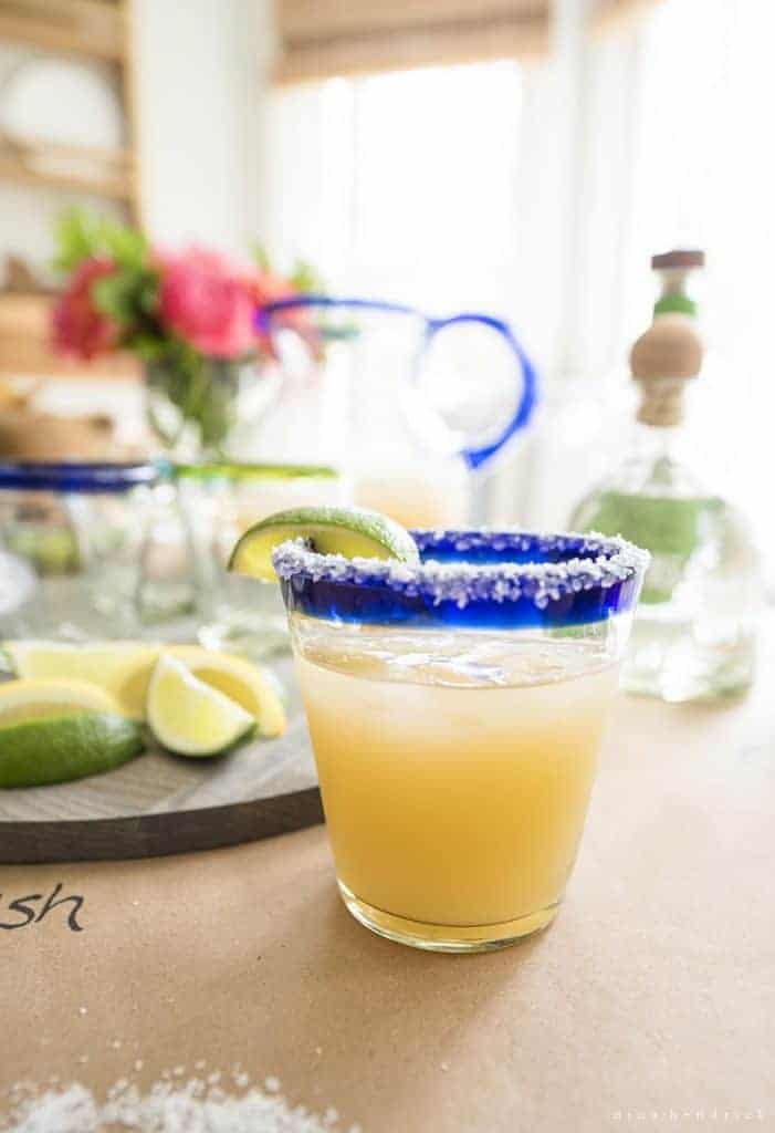 Margarita in a Mexican glass with colbalt rim and salt with a lime